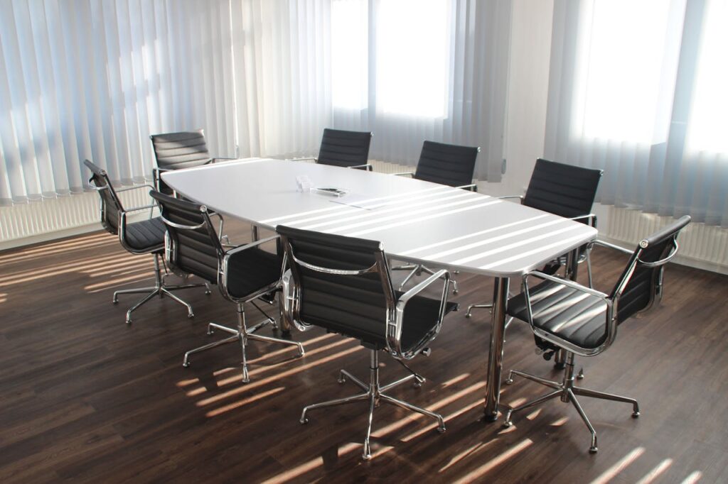 pexels photo 416320 Modern office meeting room with designer chairs, table, and large windows.